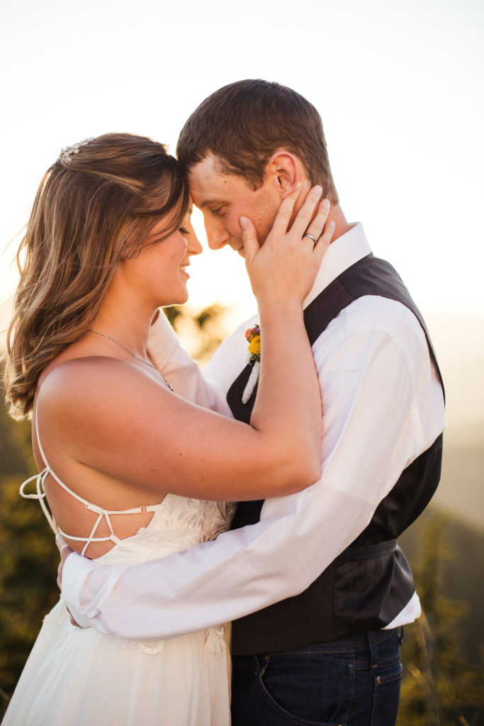 bride and groom hugging at sunset elopement
