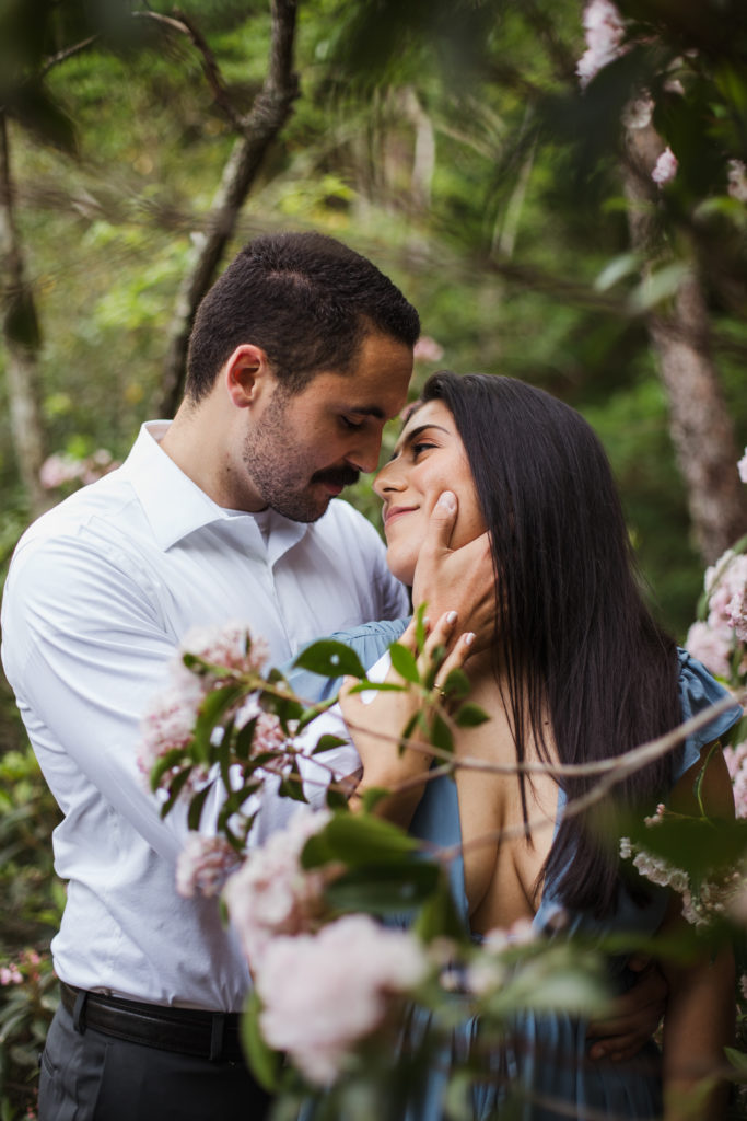 newly engaged couple hugging and kissing during engagement session