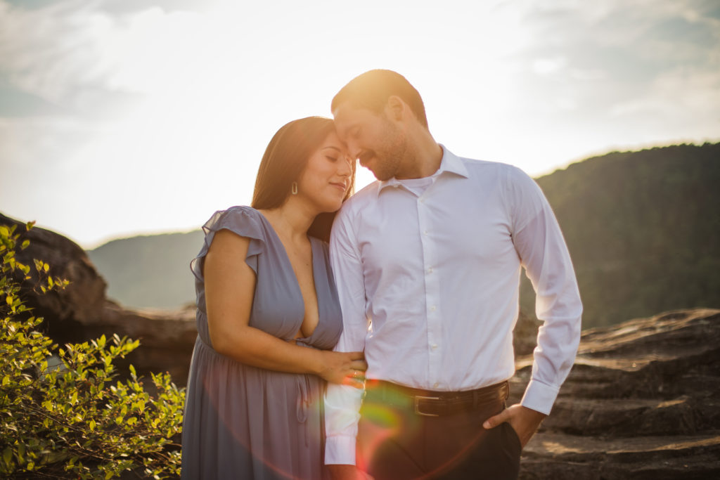 man and woman embracing during sunset engagement session