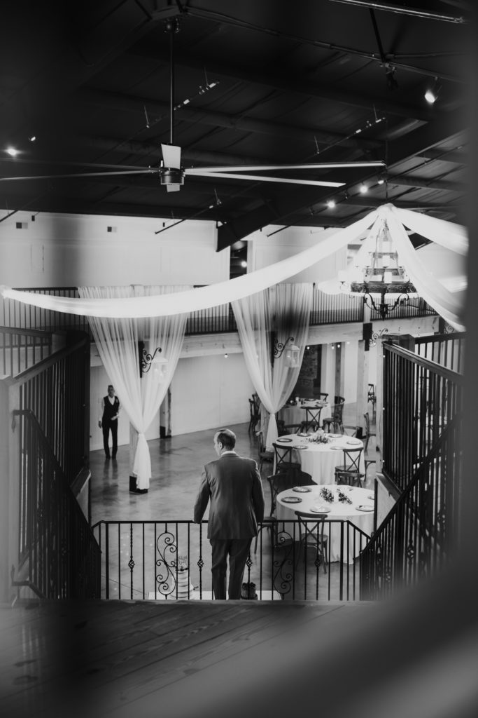black and white image of father with his back to bride before first look