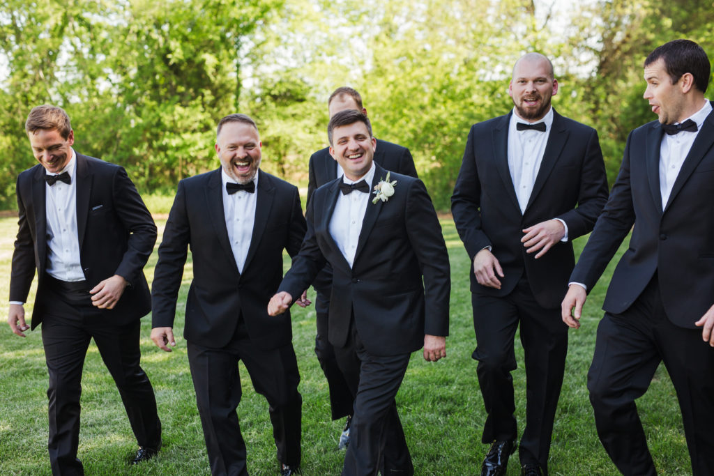 groom laughing with groomsmen 