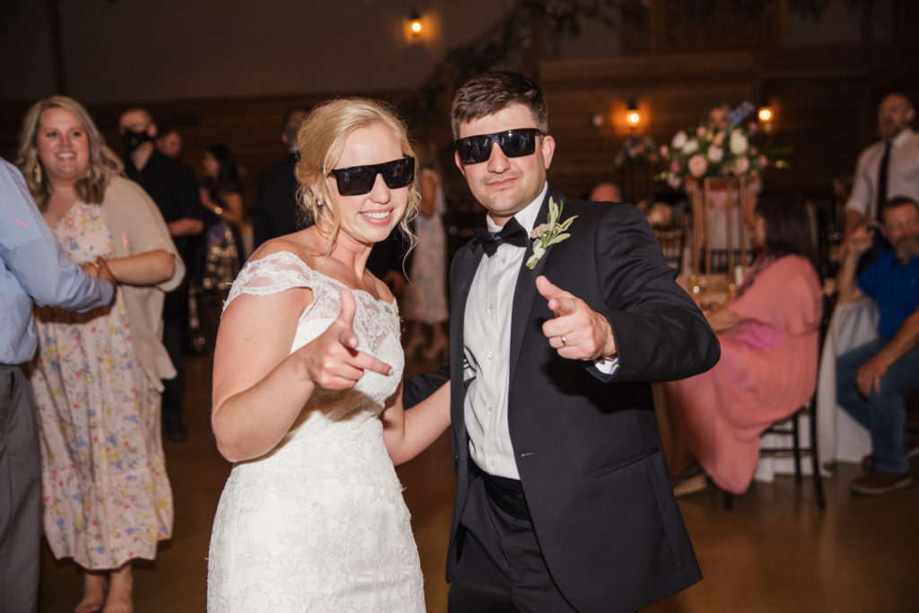 bride and groom wearing sunglasses during wedding reception at barn at sycamore farms