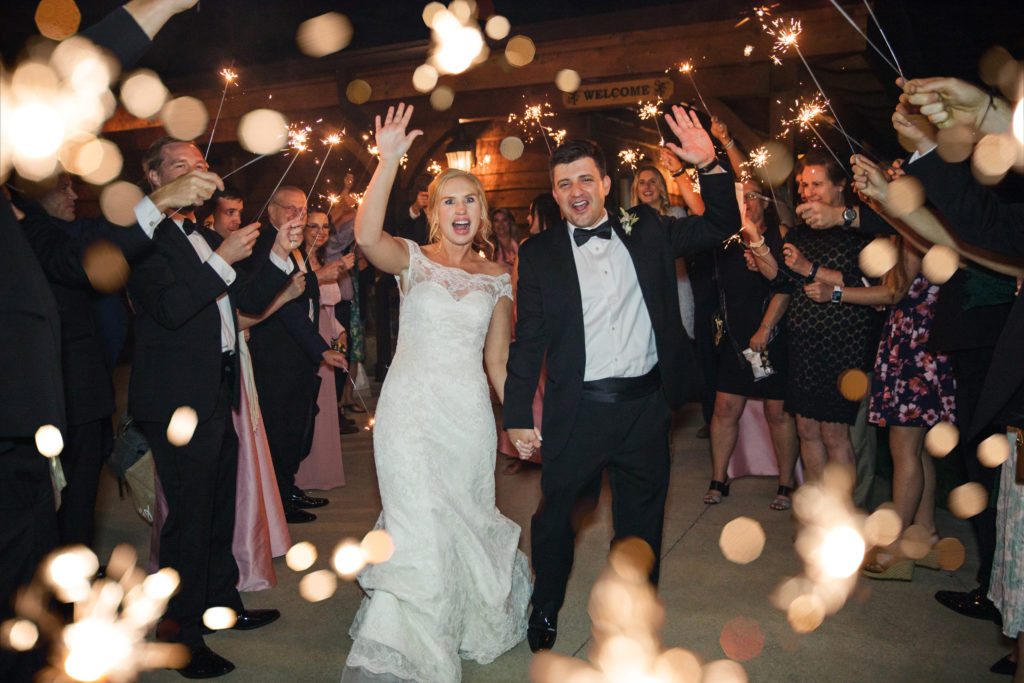couple walking through sparkler exit at barn at sycamore farms wedding