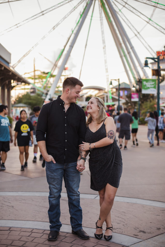 man and woman walking through the island of pigeon forge together as newly engaged couple