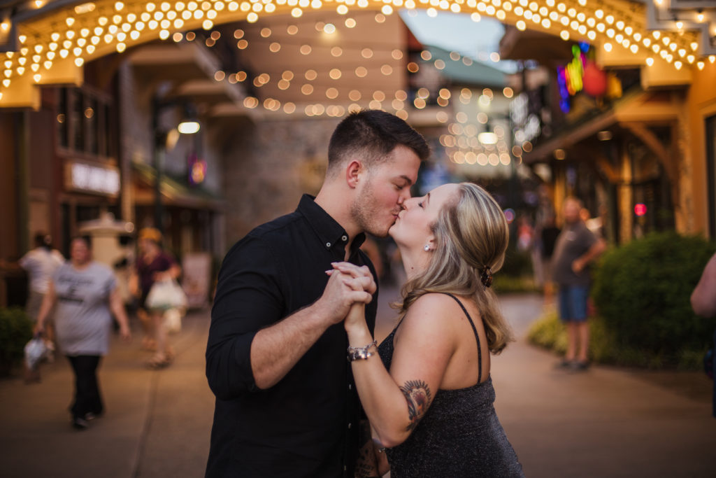 man and woman kissing at the island of pigeon forge after recent engagement