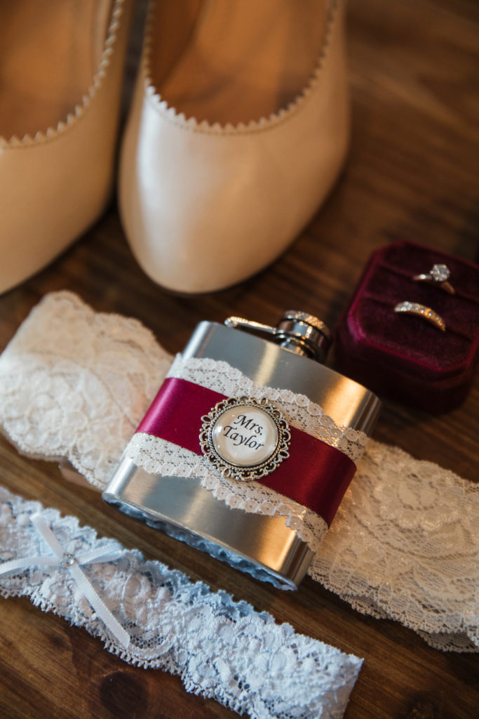 wedding detail shots with bridal shoes and flask to be worn on thigh