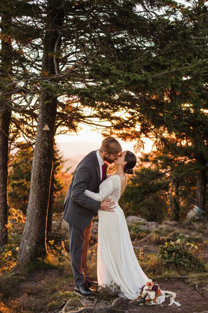 couple eloping at the top of a mountain, first kiss