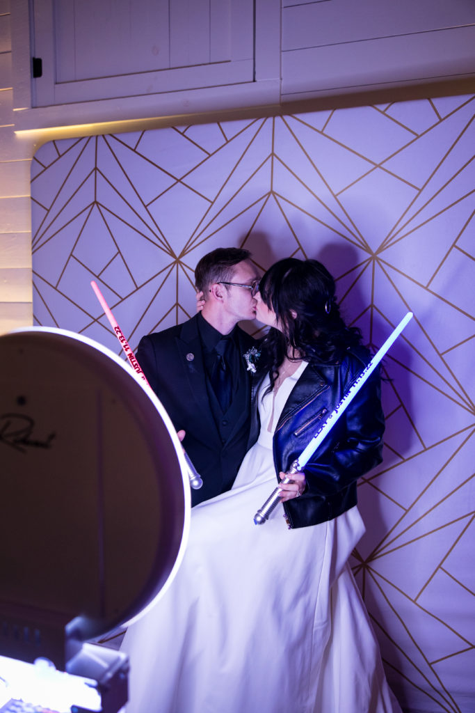 bride and groom posing for photo booth