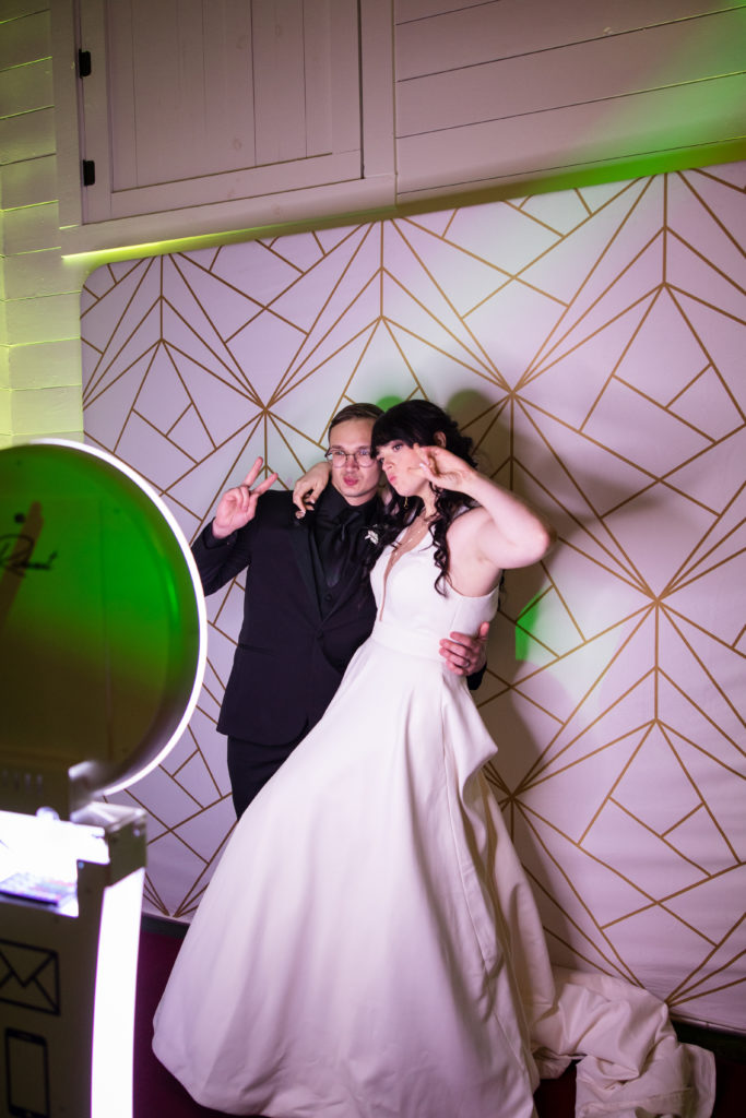 bride and groom posing for photo booth