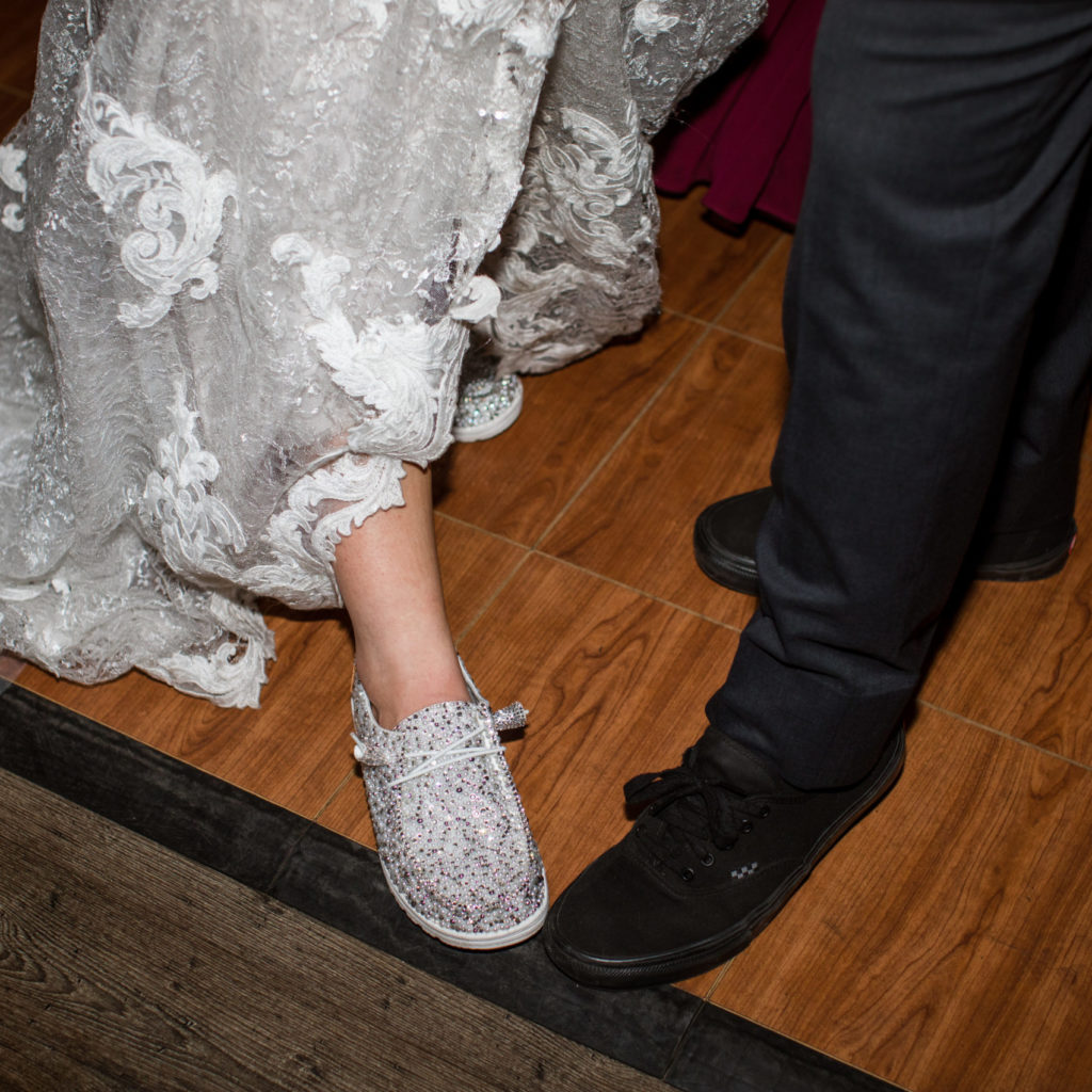bride and groom showing off their shoes