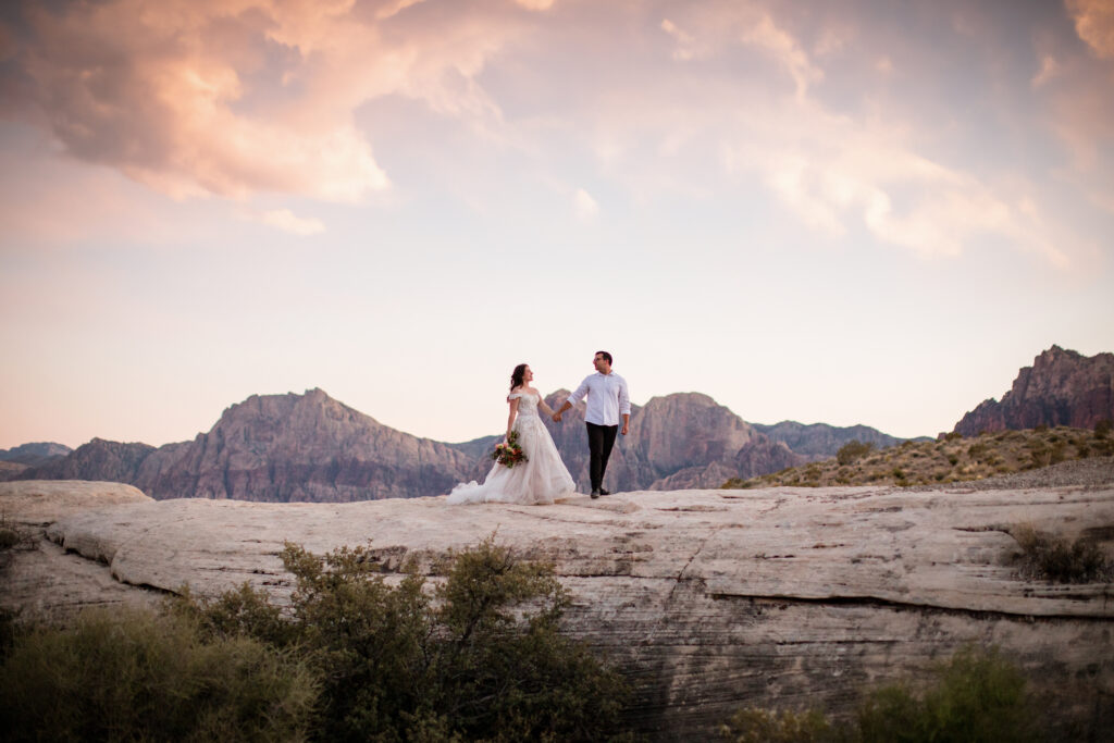 Bride and groom walking in Red Canyon